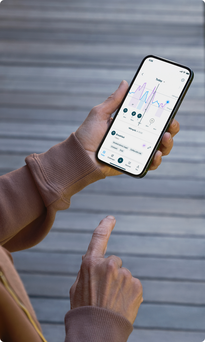 A hand holding a phone with the Lingo app open