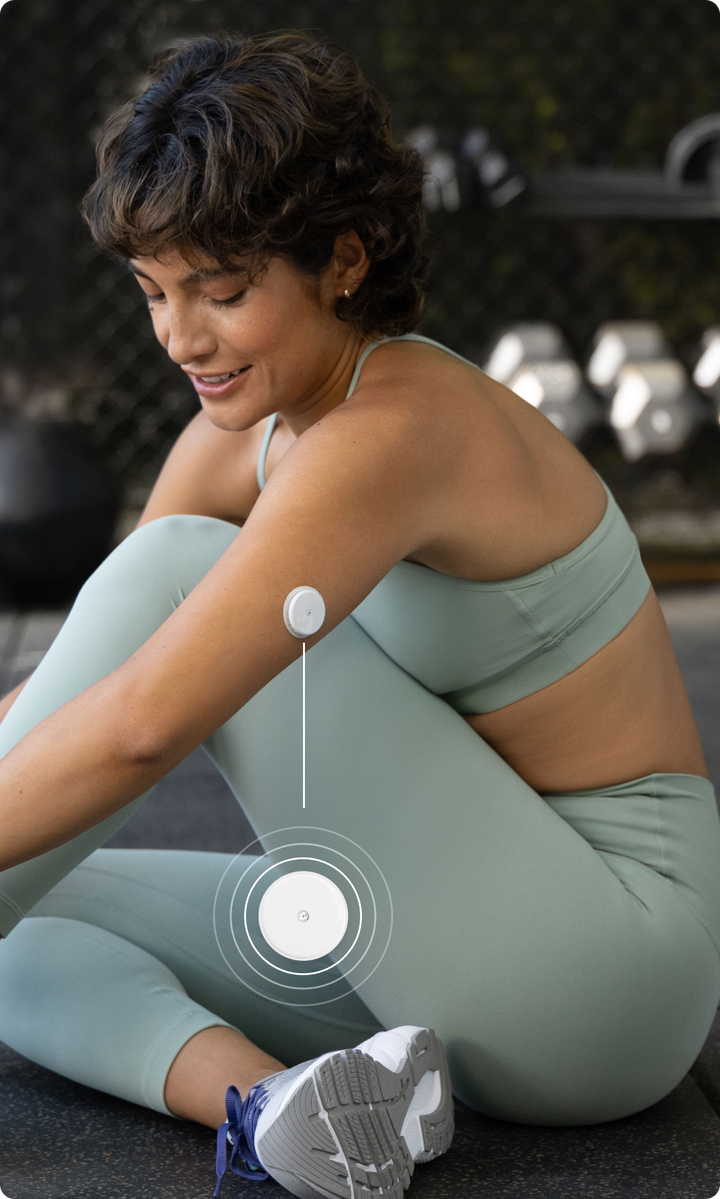 A woman wearing a Lingo biosensor on the back of her upper arm