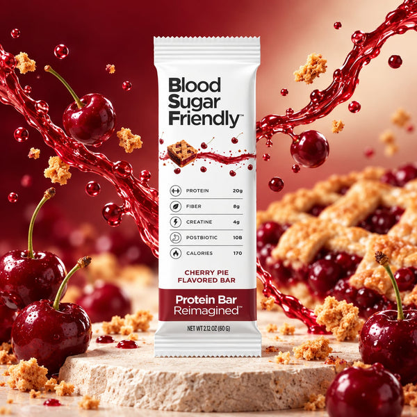Protein Bar Reimagined™ Cherry Pie bar on stone with fresh cherries, lattice cherry pie and a cherry splash