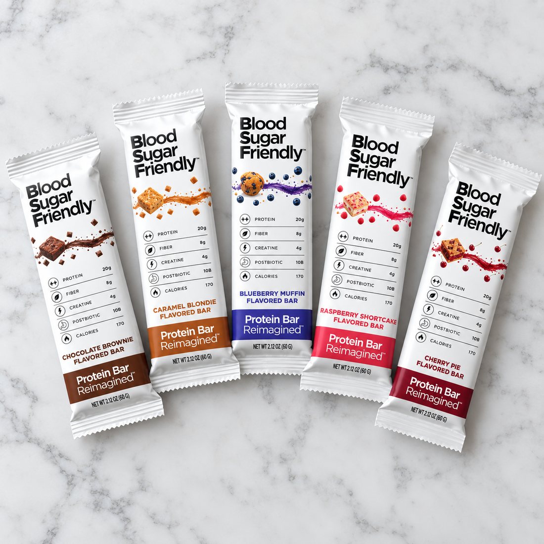 All five Protein Bar Reimagined flavors on white marble